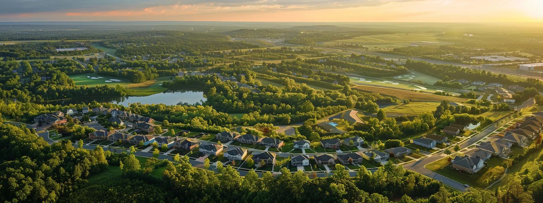 a serene landscape showcasing a vast expanse of prime land in frederick, bathed in golden sunlight, invites prospective homebuilders to envision their dream homes amidst lush greenery and clear blue skies.